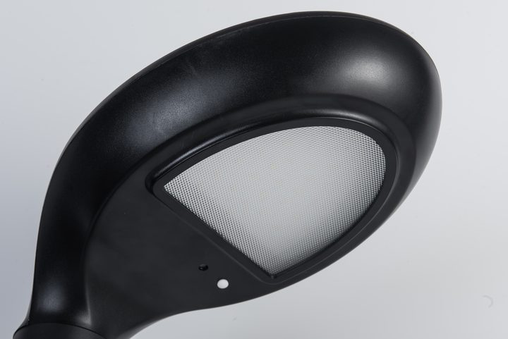 Close underside view of a curved lamp head, showing its textured diffuser and surrounding bezel.