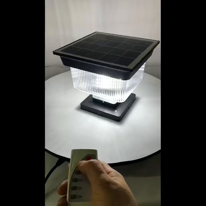 SG-9 sample with top solar panel, illuminated ribbed diffuser and a hand holding a remote