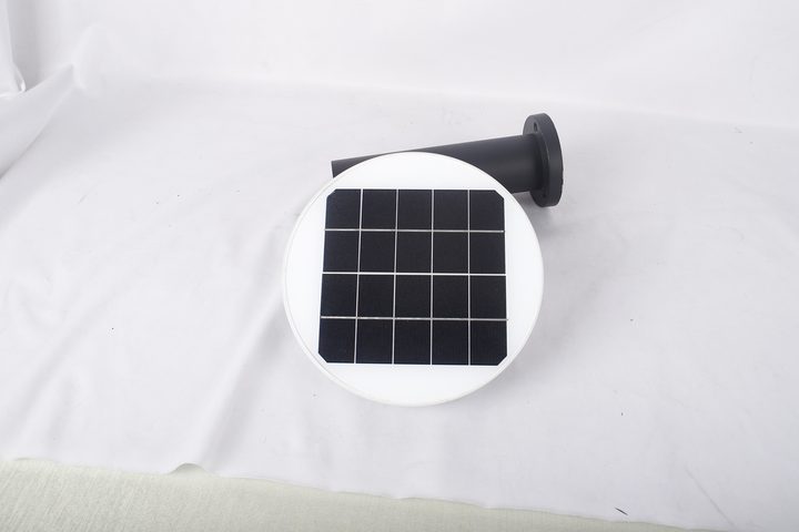Round white-rimmed lamp showing its solar-cell surface
