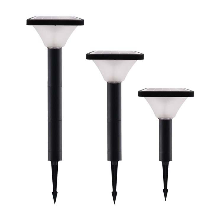 Three square-top tapered-diffuser lamps with ground spikes