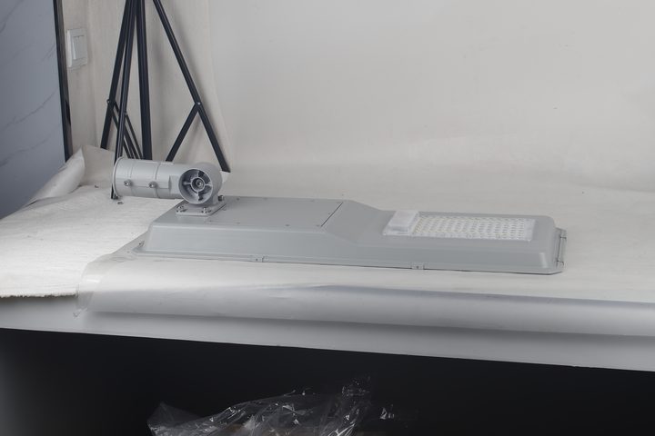 Street-light housing on a bare workshop tabletop