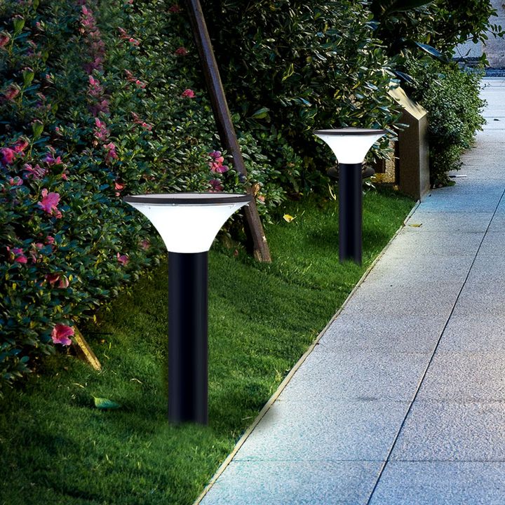 Round lamp forms beside a paved path and flowering hedge in a placement illustration.