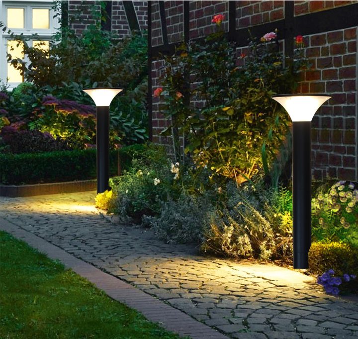 Tall round lamp forms beside a planted cobbled path in a placement illustration.