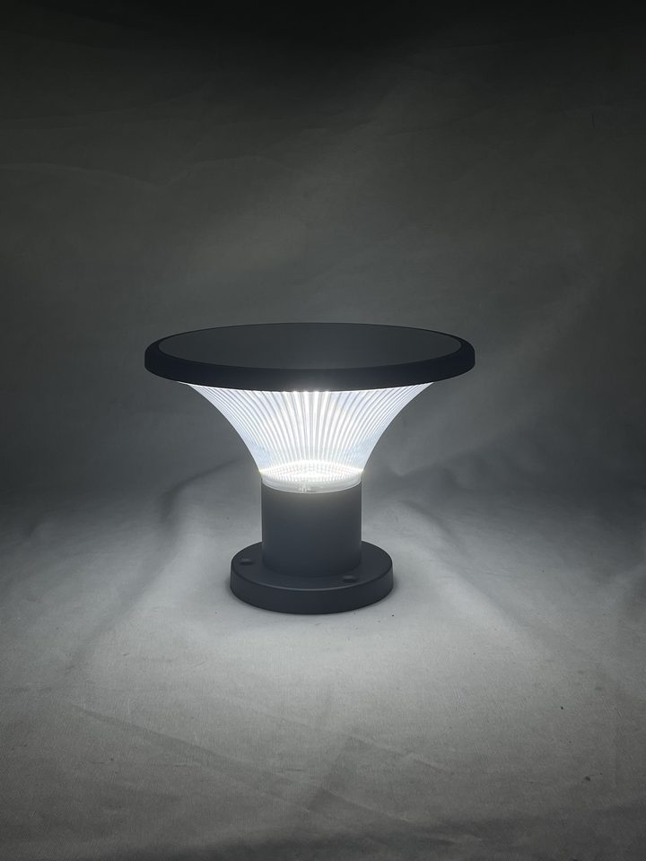 Ribbed round lamp pictured with a white-looking illuminated shade.