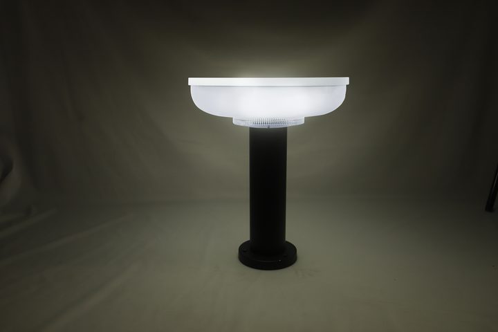 Round-head lamp pictured illuminated with a white appearance in a studio.