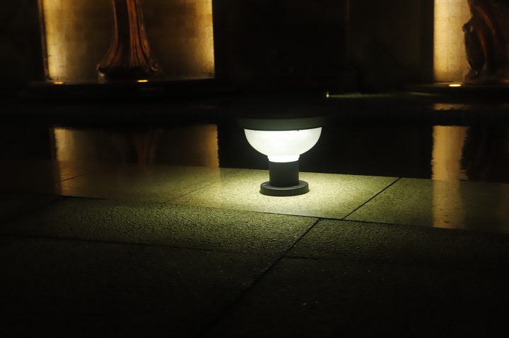 Compact bowl-shaped lamp pictured with a cooler-looking glow.